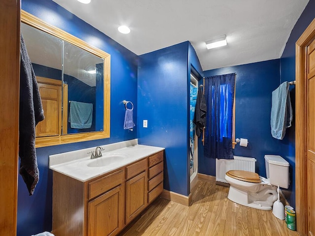 19 Falls Rd, Benton, ME 04901 - full bath featuring radiator, wood finished floors, toilet, baseboards, and vanity