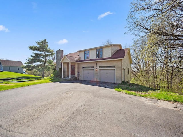 19 Falls Rd, Benton, ME 04901 - traditional-style home with asphalt driveway, an attached garage, and a chimney