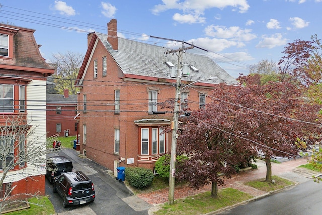 450 Cumberland Ave, Portland, ME 04101 - view of property exterior with brick siding and a chimney
