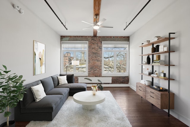 2 Main St Unit 35-203, Biddeford, ME 04005 - living room with dark wood finished floors, brick wall, ceiling fan, and baseboards