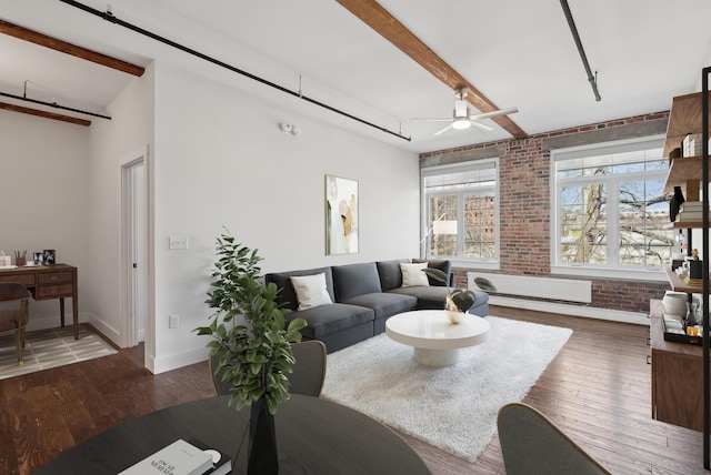 2 Main St Unit 35-203, Biddeford, ME 04005 - living room featuring brick wall, beamed ceiling, wood finished floors, a ceiling fan, and baseboards