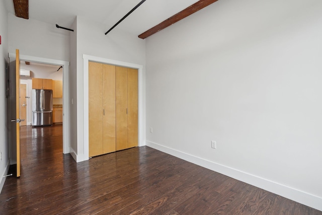 2 Main St Unit 35-203, Biddeford, ME 04005 - unfurnished bedroom with freestanding refrigerator, dark wood finished floors, baseboards, and a closet