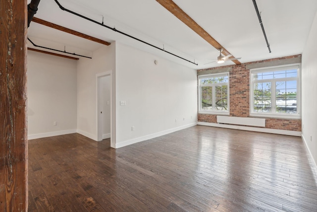 2 Main St Unit 35-203, Biddeford, ME 04005 - empty room featuring ceiling fan, dark wood finished floors, baseboards, brick wall, and beam ceiling
