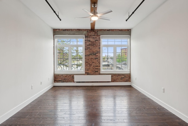 2 Main St Unit 35-203, Biddeford, ME 04005 - unfurnished room with radiator heating unit, wood-type flooring, baseboards, and brick wall