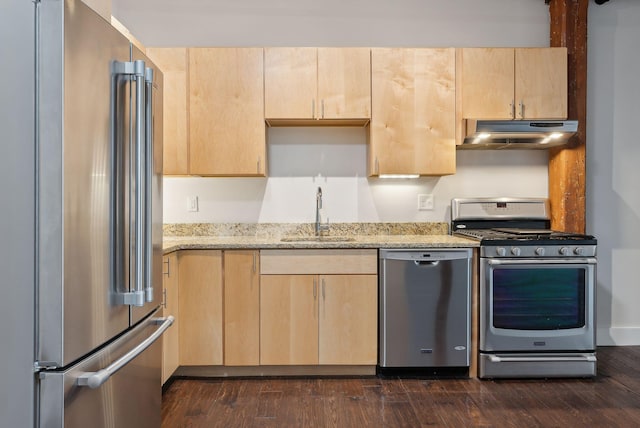 2 Main St Unit 35-203, Biddeford, ME 04005 - kitchen with stainless steel appliances, a sink, under cabinet range hood, light brown cabinetry, and light stone counters