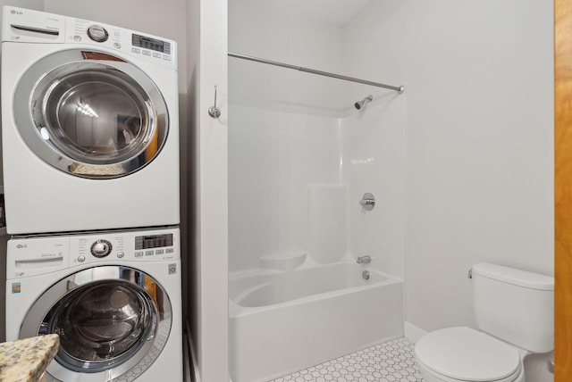 2 Main St Unit 35-203, Biddeford, ME 04005 - laundry area with stacked washer and clothes dryer, baseboards, and tile patterned floors