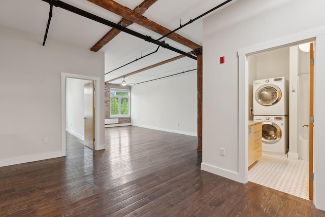 2 Main St Unit 35-203, Biddeford, ME 04005 - unfurnished living room featuring stacked washer / dryer, dark wood finished floors, baseboards, and beam ceiling