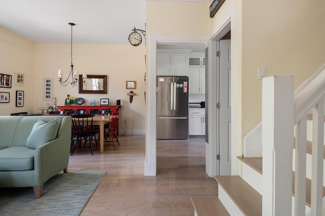 28 Ingalls Rd Unit 28, Portland, ME 04109 - corridor with wood finished floors, stairway, a chandelier, and baseboards