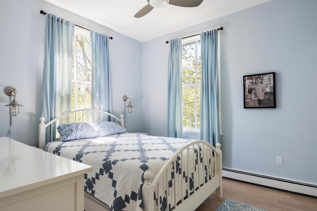 28 Ingalls Rd Unit 28, Portland, ME 04109 - bedroom featuring a baseboard heating unit, wood finished floors, and ceiling fan