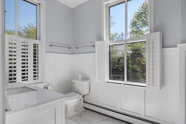 28 Ingalls Rd Unit 28, Portland, ME 04109 - bathroom featuring a baseboard radiator, a decorative wall, marble finish floors, toilet, and wainscoting
