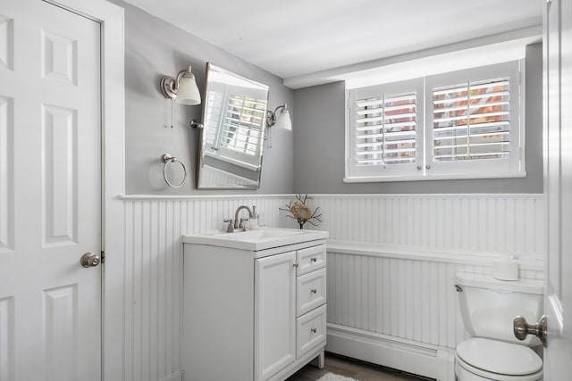 28 Ingalls Rd Unit 28, Portland, ME 04109 - half bath featuring wainscoting, baseboard heating, toilet, and vanity