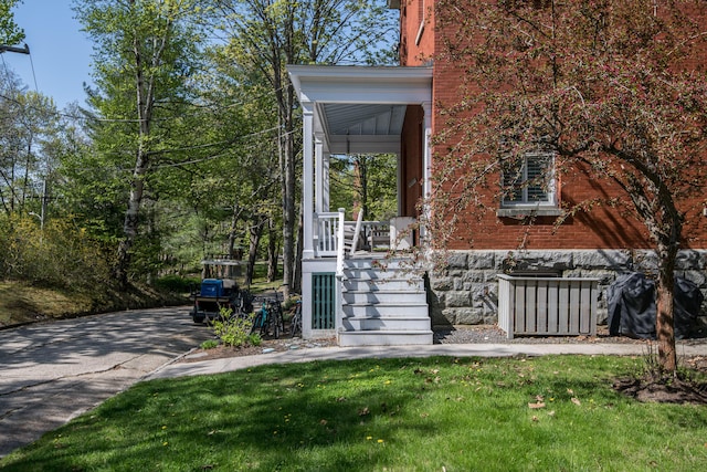28 Ingalls Rd Unit 28, Portland, ME 04109 - view of front of home with a porch, a front lawn, and brick siding