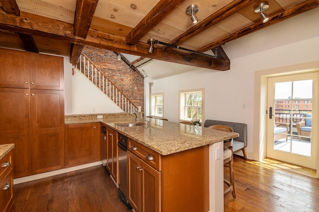 32 Pleasant St Unit 3, Portland, ME 04101 - kitchen with a sink, brown cabinetry, a peninsula, and dark wood-style flooring