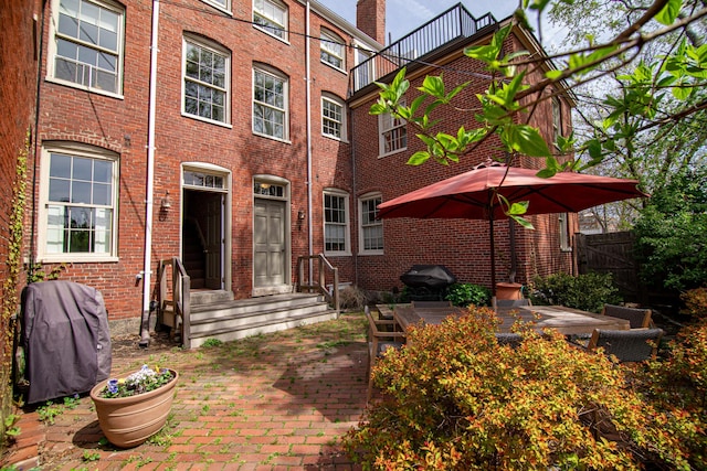 32 Pleasant St Unit 3, Portland, ME 04101 - rear view of property with brick siding and a patio