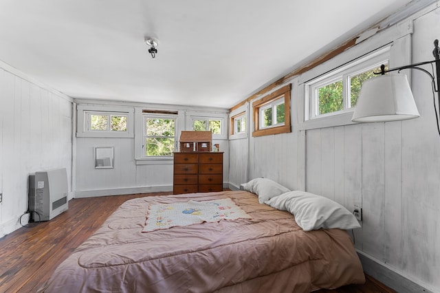 103 Green St, Augusta, ME 04330 - bedroom featuring wood finished floors, heating unit, wood walls, and baseboards