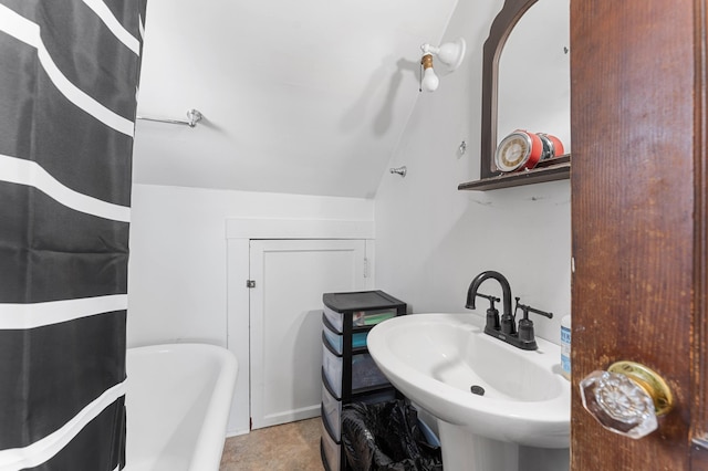103 Green St, Augusta, ME 04330 - bathroom featuring a sink, a tub to relax in, vaulted ceiling, and a shower with shower curtain