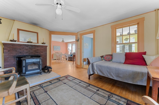 103 Green St, Augusta, ME 04330 - bedroom with wood-type flooring, a wood stove, and ceiling fan