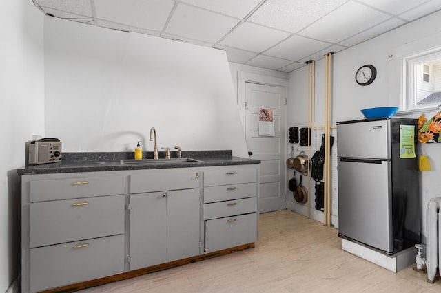 103 Green St, Augusta, ME 04330 - kitchen with freestanding refrigerator, a sink, gray cabinetry, dark countertops, and a drop ceiling
