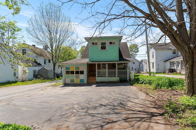 103 Green St, Augusta, ME 04330 - view of front of home with a porch, asphalt driveway, a residential view, and a garage