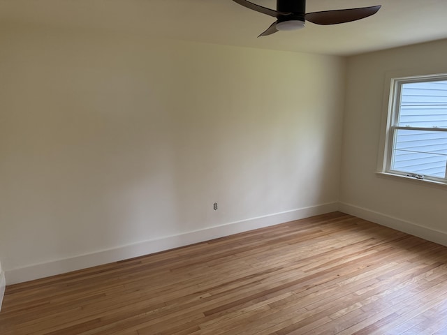 24 Chapel St, Boothbay, ME 04537 - empty room with ceiling fan, light wood finished floors, and baseboards