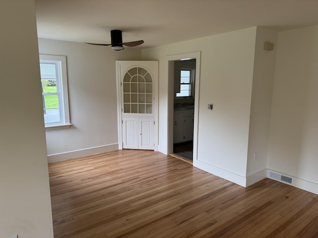 24 Chapel St, Boothbay, ME 04537 - unfurnished room with light wood finished floors, ceiling fan, and baseboards