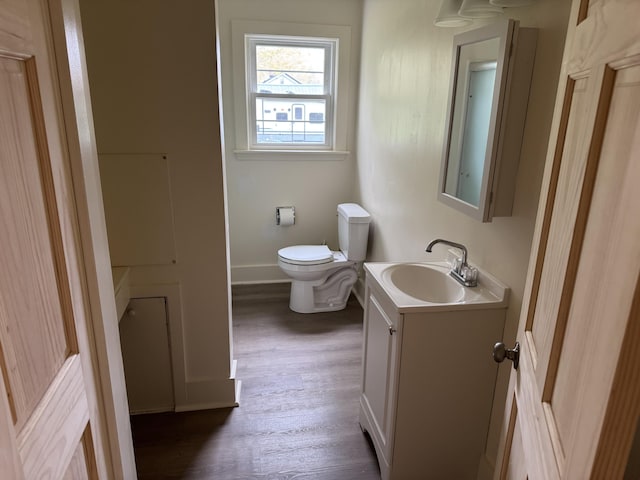 24 Chapel St, Boothbay, ME 04537 - bathroom featuring vanity, toilet, wood finished floors, and baseboards