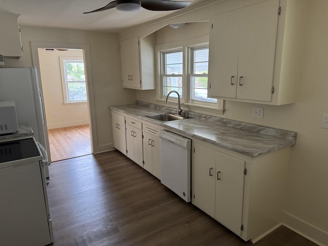 24 Chapel St, Boothbay, ME 04537 - kitchen with white dishwasher, a sink, range, and plenty of natural light