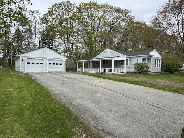 24 Chapel St, Boothbay, ME 04537 - ranch-style home with covered porch, a detached garage, a chimney, a front yard, and an outbuilding