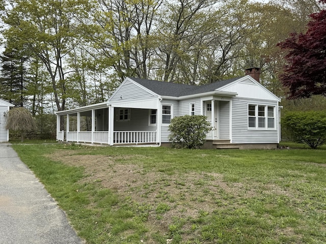 24 Chapel St, Boothbay, ME 04537 - view of front facade with a chimney, a front yard, and driveway