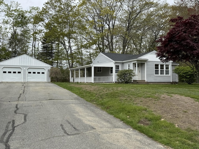 24 Chapel St, Boothbay, ME 04537 - view of front of home featuring a garage, a front yard, a porch, and an outbuilding