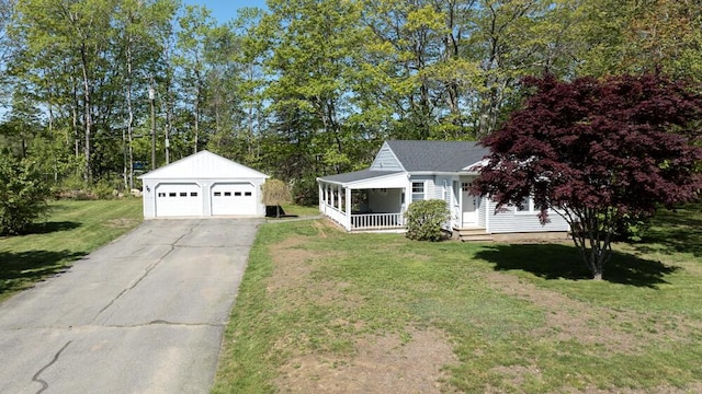 24 Chapel St, Boothbay, ME 04537 - view of front of home with an outbuilding, a detached garage, covered porch, and a front yard