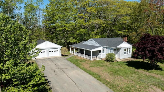 24 Chapel St, Boothbay, ME 04537 - view of front facade with a porch, an outdoor structure, a chimney, a front lawn, and a detached garage