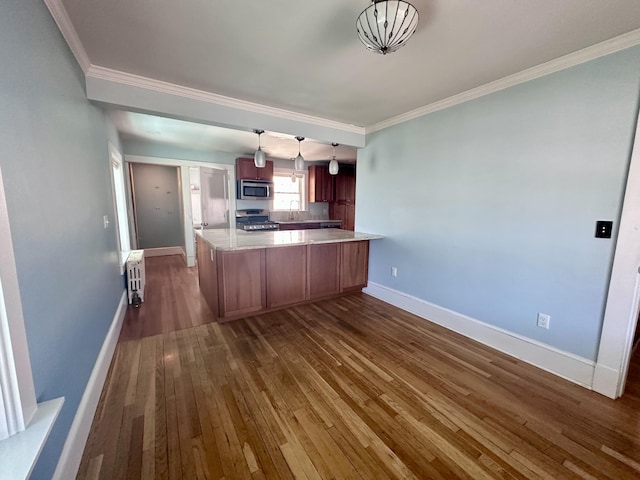 128 Fern St, Bangor, ME 04401 - kitchen with appliances with stainless steel finishes, dark wood-style floors, a peninsula, a sink, and baseboards