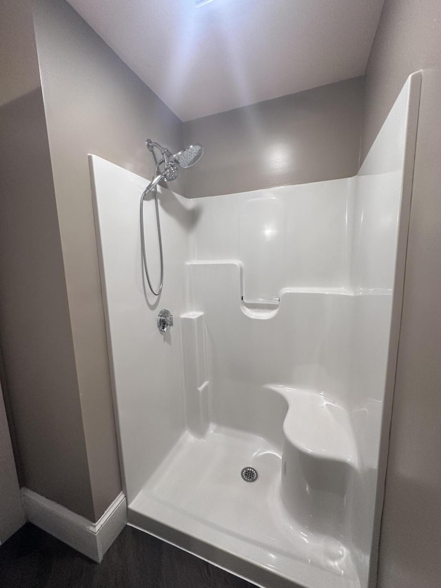128 Fern St, Bangor, ME 04401 - bathroom with a shower, wood finished floors, and baseboards