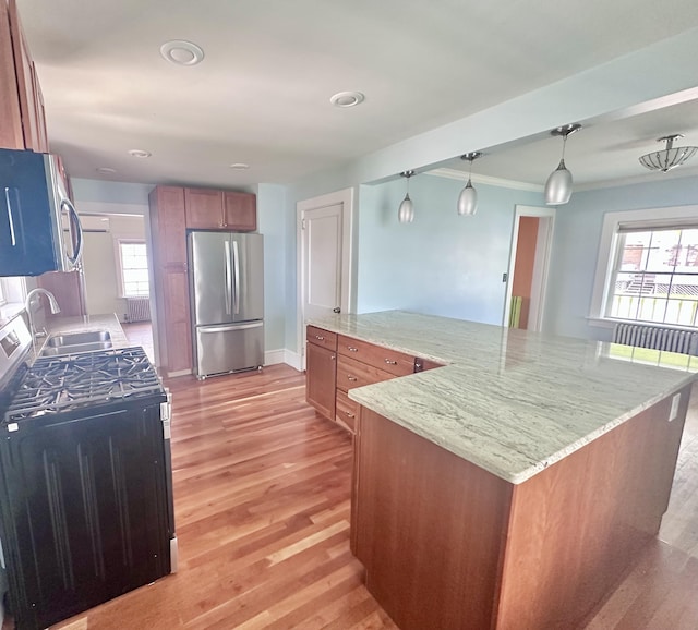 128 Fern St, Bangor, ME 04401 - kitchen featuring appliances with stainless steel finishes, a sink, light wood finished floors, brown cabinets, and recessed lighting