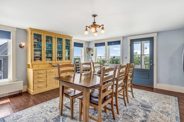 661 Veterans Hwy, Brooks, ME 04921 - dining space with radiator, a chandelier, and dark wood finished floors