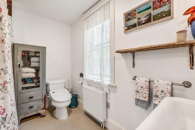 661 Veterans Hwy, Brooks, ME 04921 - full bath with radiator heating unit, plenty of natural light, and a tub to relax in