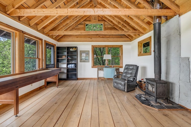 661 Veterans Hwy, Brooks, ME 04921 - living area featuring a wood stove, hardwood / wood-style floors, a wood ceiling with exposed beams, and high vaulted ceiling