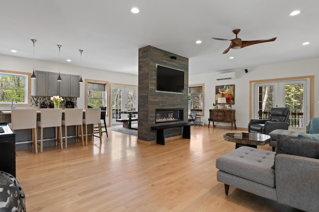 64 Old Kings Hwy, Ogunquit, ME 03907 - living room featuring french doors, a wall mounted air conditioner, ceiling fan, healthy amount of natural light, and recessed lighting