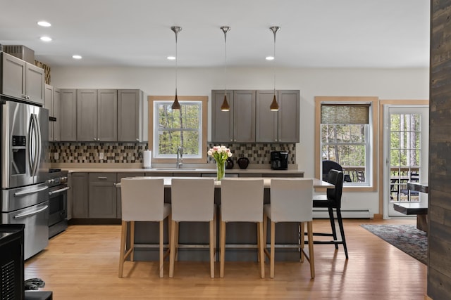 64 Old Kings Hwy, Ogunquit, ME 03907 - kitchen with appliances with stainless steel finishes, a breakfast bar area, tasteful backsplash, recessed lighting, and light countertops