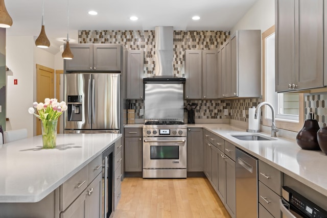 64 Old Kings Hwy, Ogunquit, ME 03907 - kitchen with stainless steel appliances, a sink, wall chimney exhaust hood, wine cooler, and decorative backsplash