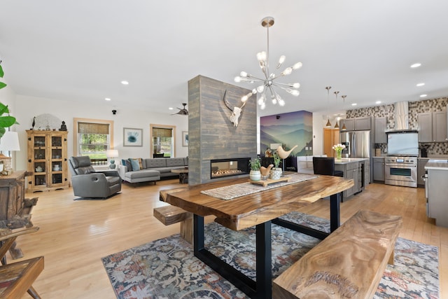 64 Old Kings Hwy, Ogunquit, ME 03907 - dining area featuring light wood-style flooring, a chandelier, a tiled fireplace, and recessed lighting