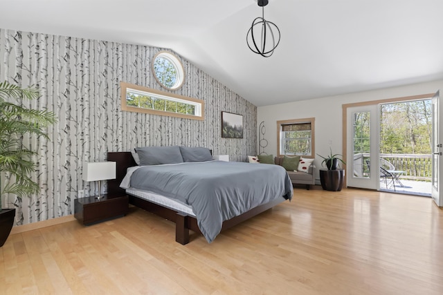 64 Old Kings Hwy, Ogunquit, ME 03907 - bedroom with wallpapered walls, an accent wall, lofted ceiling, access to outside, and wood finished floors