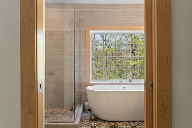 64 Old Kings Hwy, Ogunquit, ME 03907 - bathroom with a shower stall, a freestanding tub, and plenty of natural light