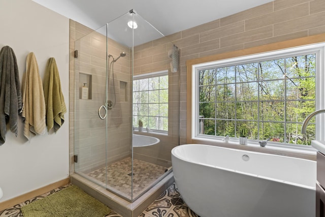64 Old Kings Hwy, Ogunquit, ME 03907 - full bath featuring a shower stall, a freestanding bath, and baseboards