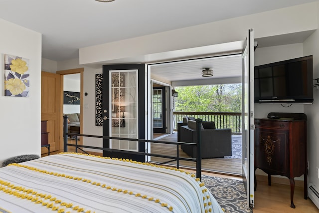64 Old Kings Hwy, Ogunquit, ME 03907 - bedroom featuring wood finished floors, a baseboard heating unit, and access to outside