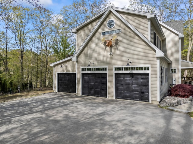 64 Old Kings Hwy, Ogunquit, ME 03907 - view of side of home with asphalt driveway and an attached garage