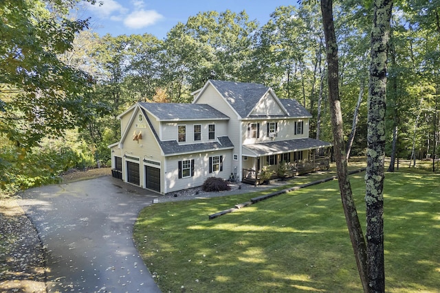 64 Old Kings Hwy, Ogunquit, ME 03907 - view of front of home with an attached garage, asphalt driveway, a front lawn, a porch, and roof with shingles