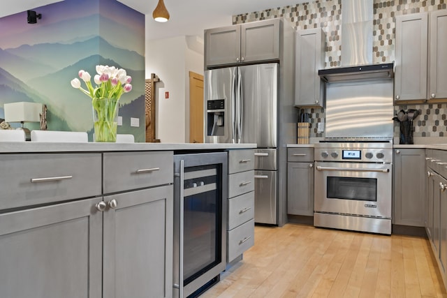64 Old Kings Hwy, Ogunquit, ME 03907 - kitchen with appliances with stainless steel finishes, wine cooler, gray cabinets, and decorative backsplash