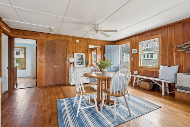 13 Atlantic Cir, Kennebunk, ME 04043 - dining room with wood walls, a ceiling fan, attic access, wood finished floors, and heating unit
